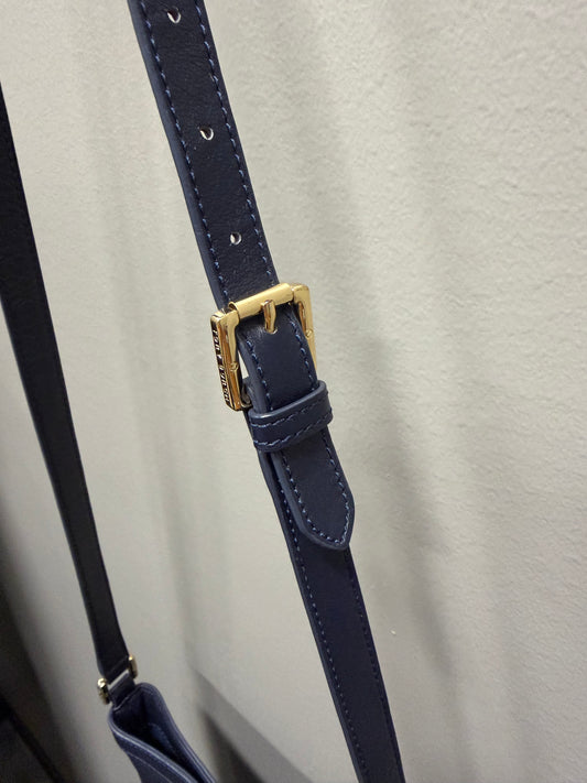 Navy leather belt with a gold buckle on a light gray background