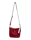 Red handbag with a strap on a white background