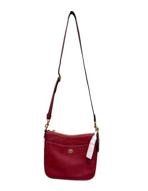 Red handbag with a strap on a white background