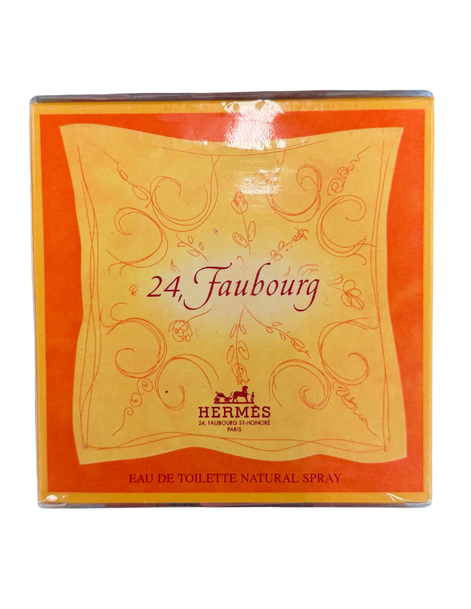 Hermes 24 Faubourg Eau de Toilette Natural Spray packaging box, featuring a vibrant orange border and a central pale yellow panel with elegant red script and floral scrollwork.